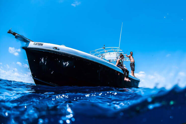 Image of the Florida Shark Diving boat with guests on-board for a stellar shark diving charter!